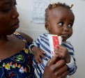 Susan* and her daughter Hawi* visit the Kayole Soweto health centre to measure her weight and height to asses for malnutrition.  Photo: Shaloam Strooper/Concern Worldwide