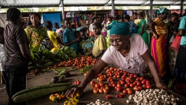 A woman displays her vegetables for sale at a central market in DRC