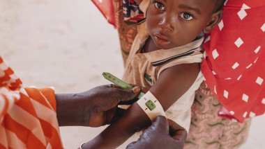A child in Niger having their mid-upper arm circumference measured to screen for malnutrition