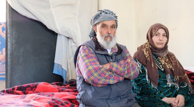 A husband and wife look into the camera