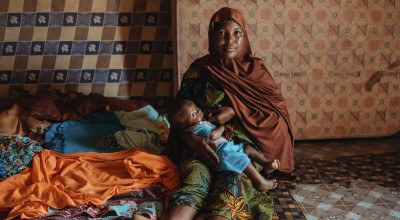 A mother breastfeeds her young baby
