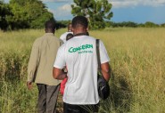 Concern team member, Sam (26) takes a camera to document the damage to crops in Nsendje.  Photo: Gavin Douglas/Concern Worldwide